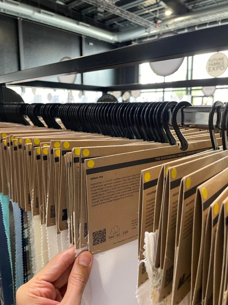 Sustainable fabric sample collection displayed at a textile expo showcasing eco-friendly and ethically sourced textile materials