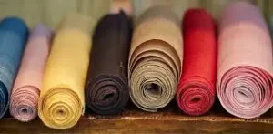 Rolled colorful fabric textiles representing GOTS-certified fabric dyeing and sustainable organic textile production