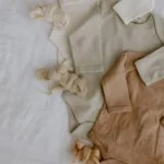 Organic cotton baby clothing and fabric essentials representing sustainable textile sourcing and ethical fashion production