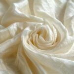 What Is Peace Silk & Why Are Ethical Fashion Brands in the UK & EU Choosing It Over Conventional Silk? 2 Soft ivory peace silk fabric representing ethical silk production and sustainable luxury textiles