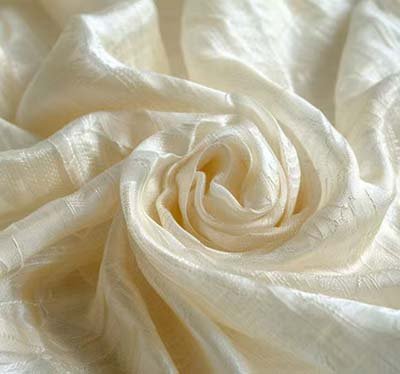 Soft ivory peace silk fabric representing ethical silk production and sustainable luxury textiles